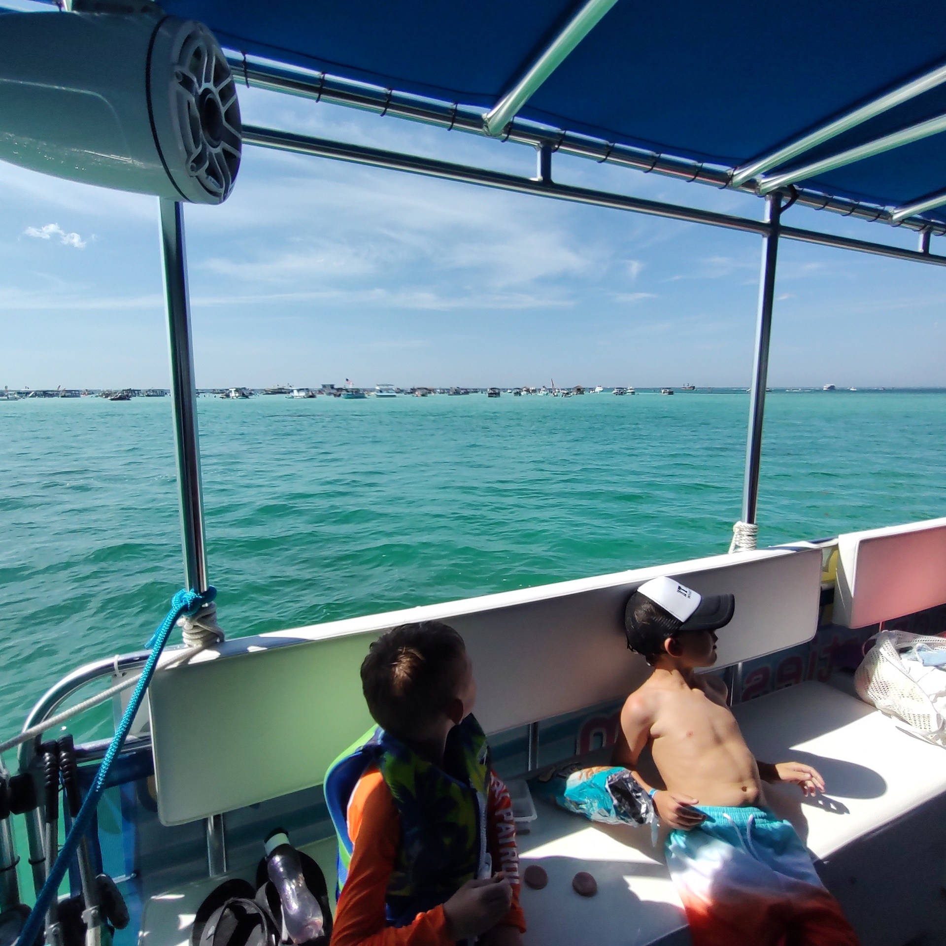 a group of people sitting in a boat on a body of water