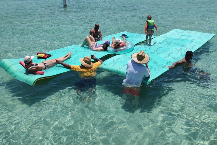 a group of people riding on the back of a boat